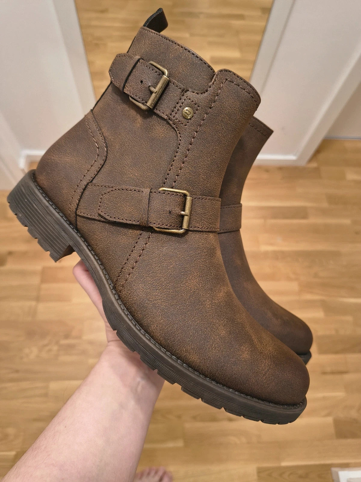 Deakins brown biker boots with antique metal buckles and side zipper, robust leather look.