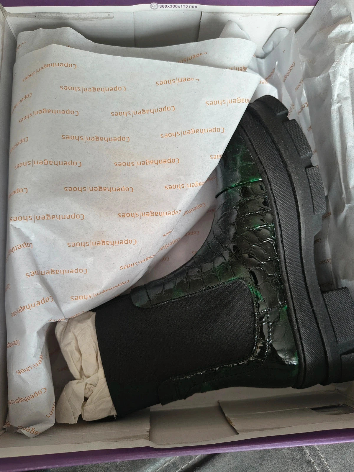 Copenhagen Shoes black and green leather Chelsea boots with crocodile pattern and elastic side inserts.