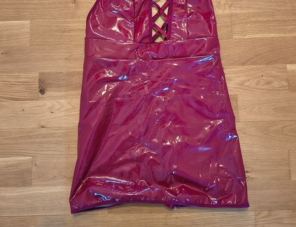 Bordeaux burgundy bandage dress with lace-up detail and glossy vinyl appearance.