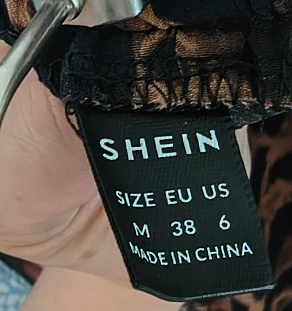 SheIn brown animal print flared pants synthetic material with leopard pattern.