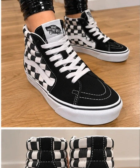 VANS black and white checkerboard high-top trainers with classic side stripe and leather material.