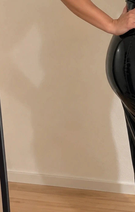 REI black linen maxi dress with shiny finish, high collar, and front zipper.