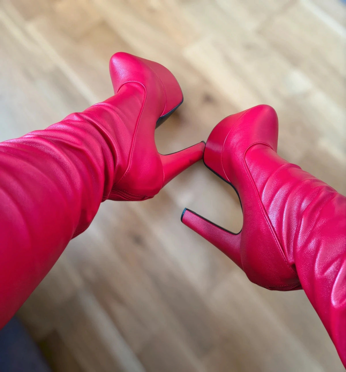 REI red overknee boots synthetic material with zipper and platform sole.