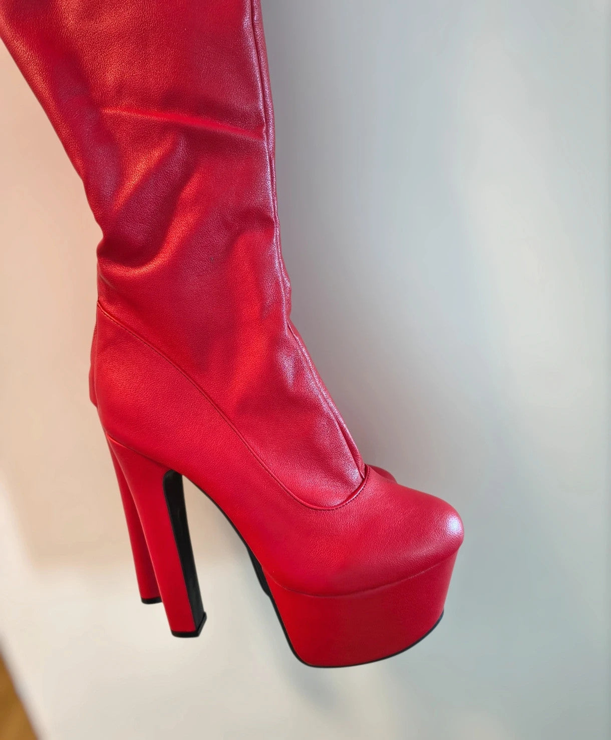 REI red overknee boots synthetic material with zipper and platform sole.