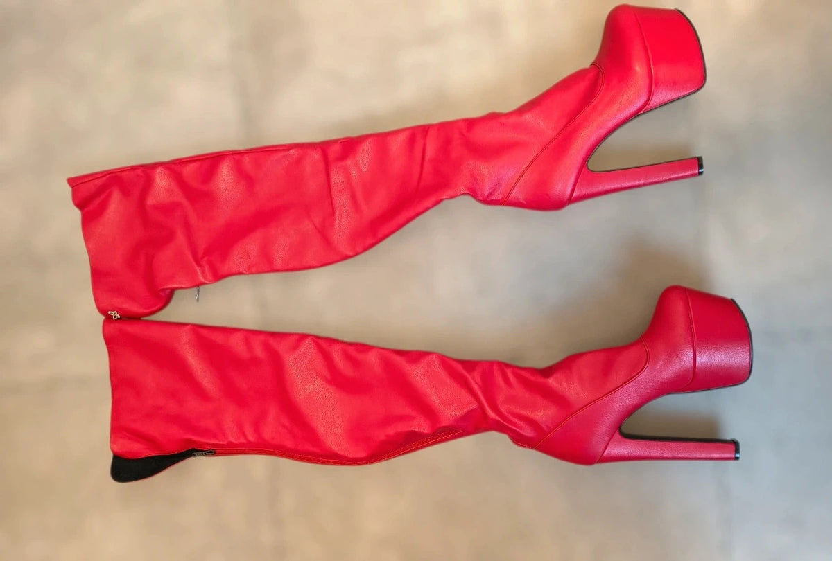 REI red overknee boots synthetic material with zipper and platform sole.