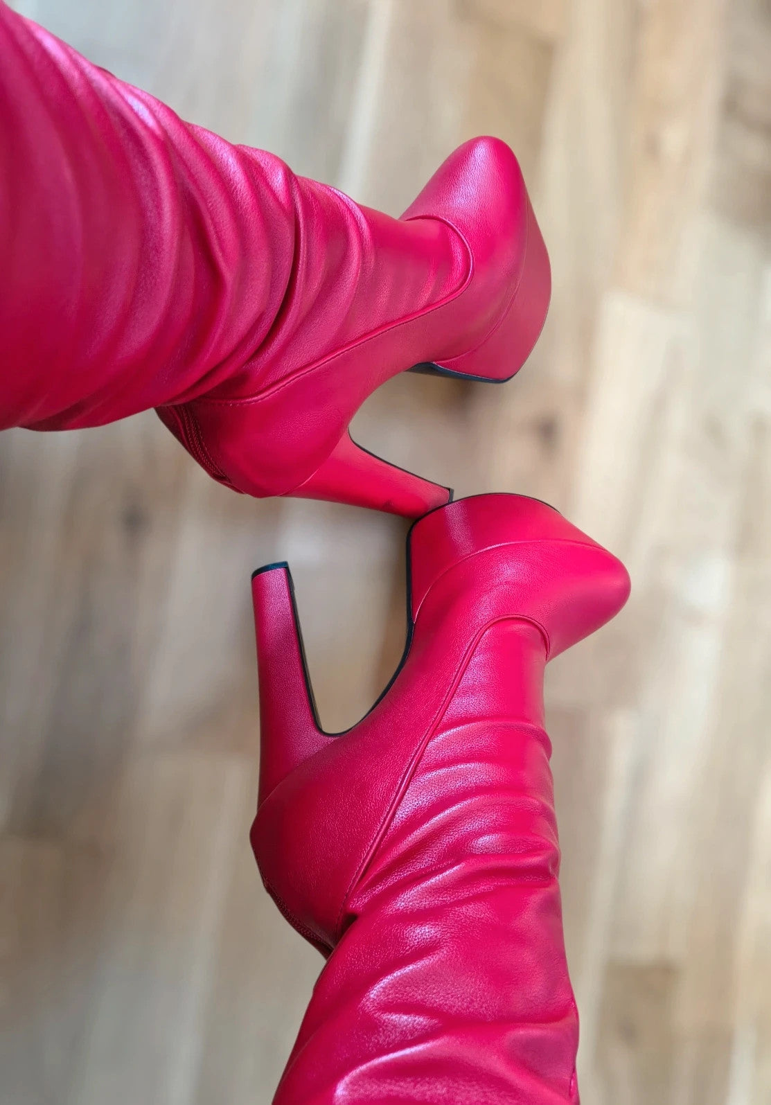 REI red overknee boots synthetic material with zipper and platform sole.