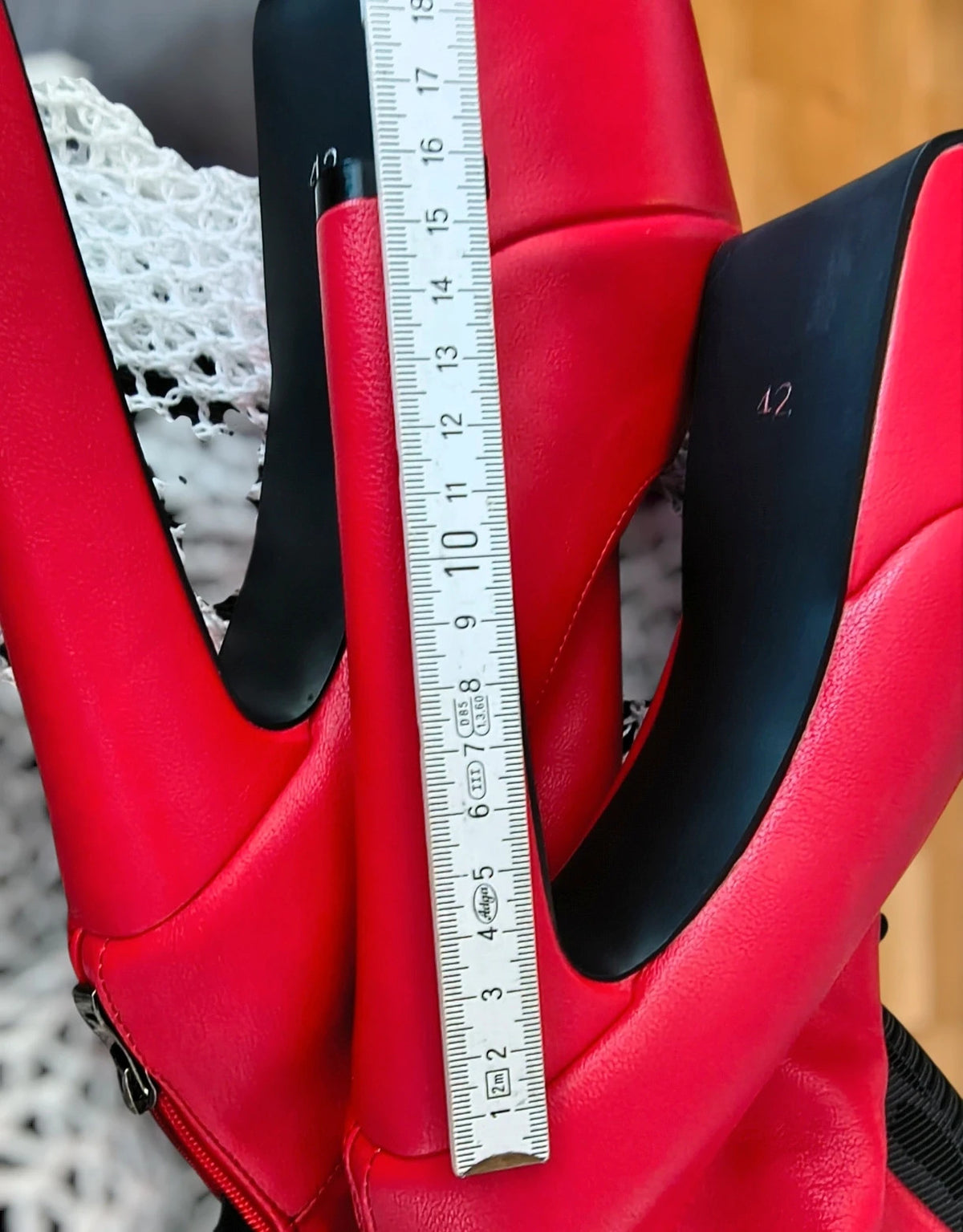 REI red overknee boots synthetic material with zipper and platform sole.