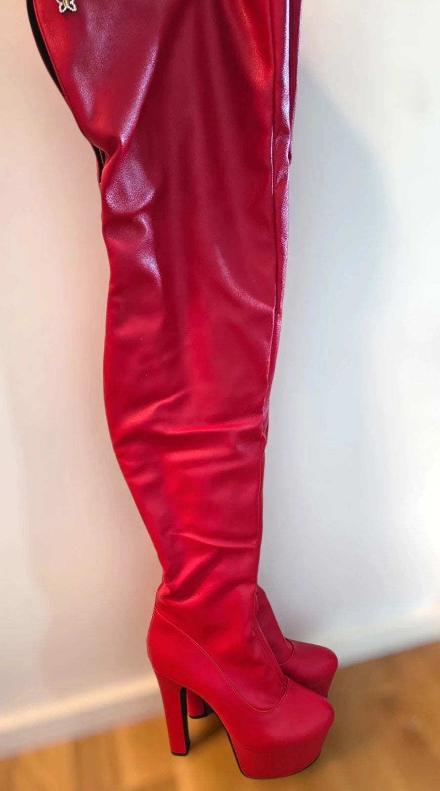 REI red overknee boots synthetic material with zipper and platform sole.