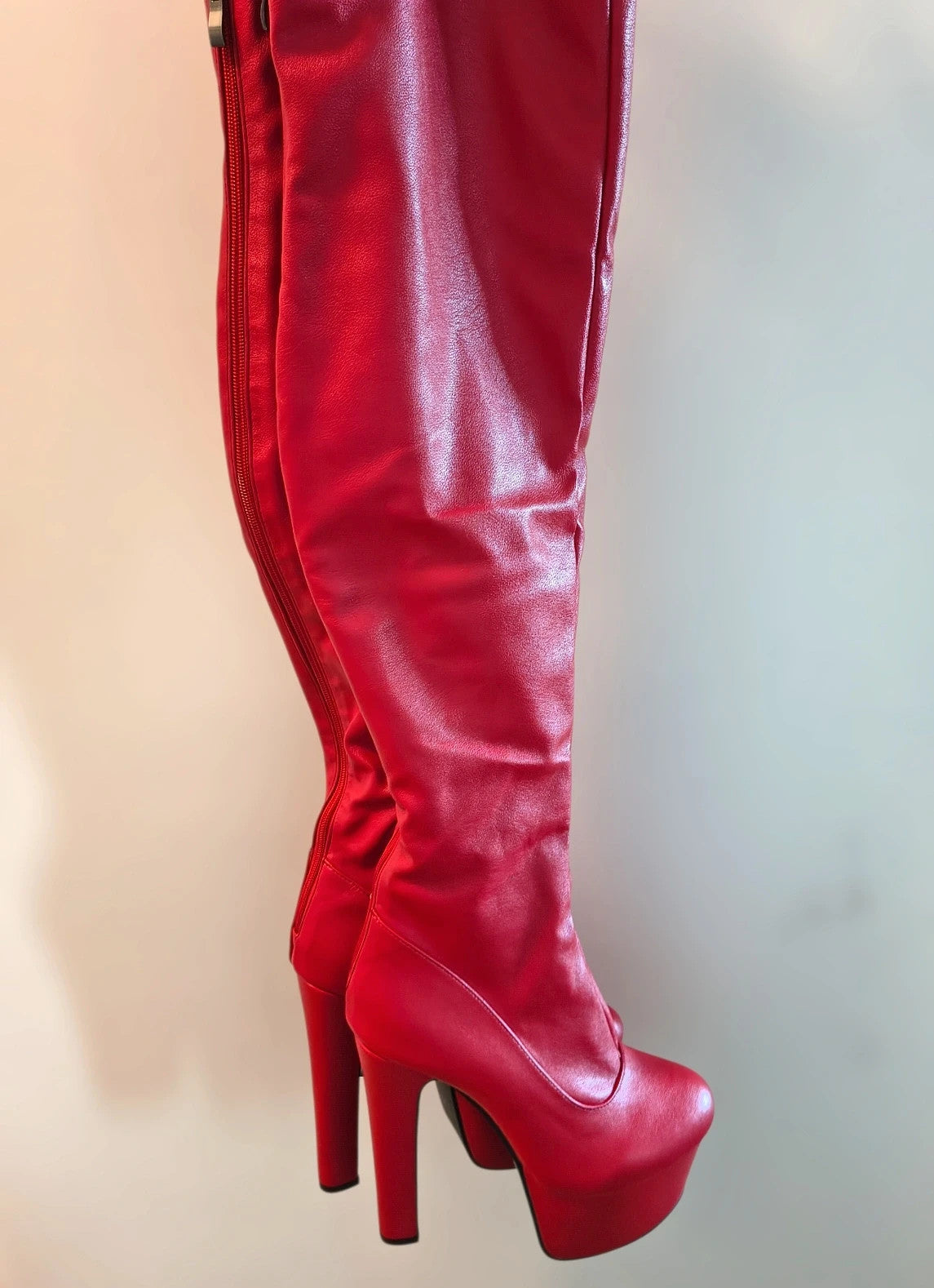 REI red overknee boots synthetic material with zipper and platform sole.