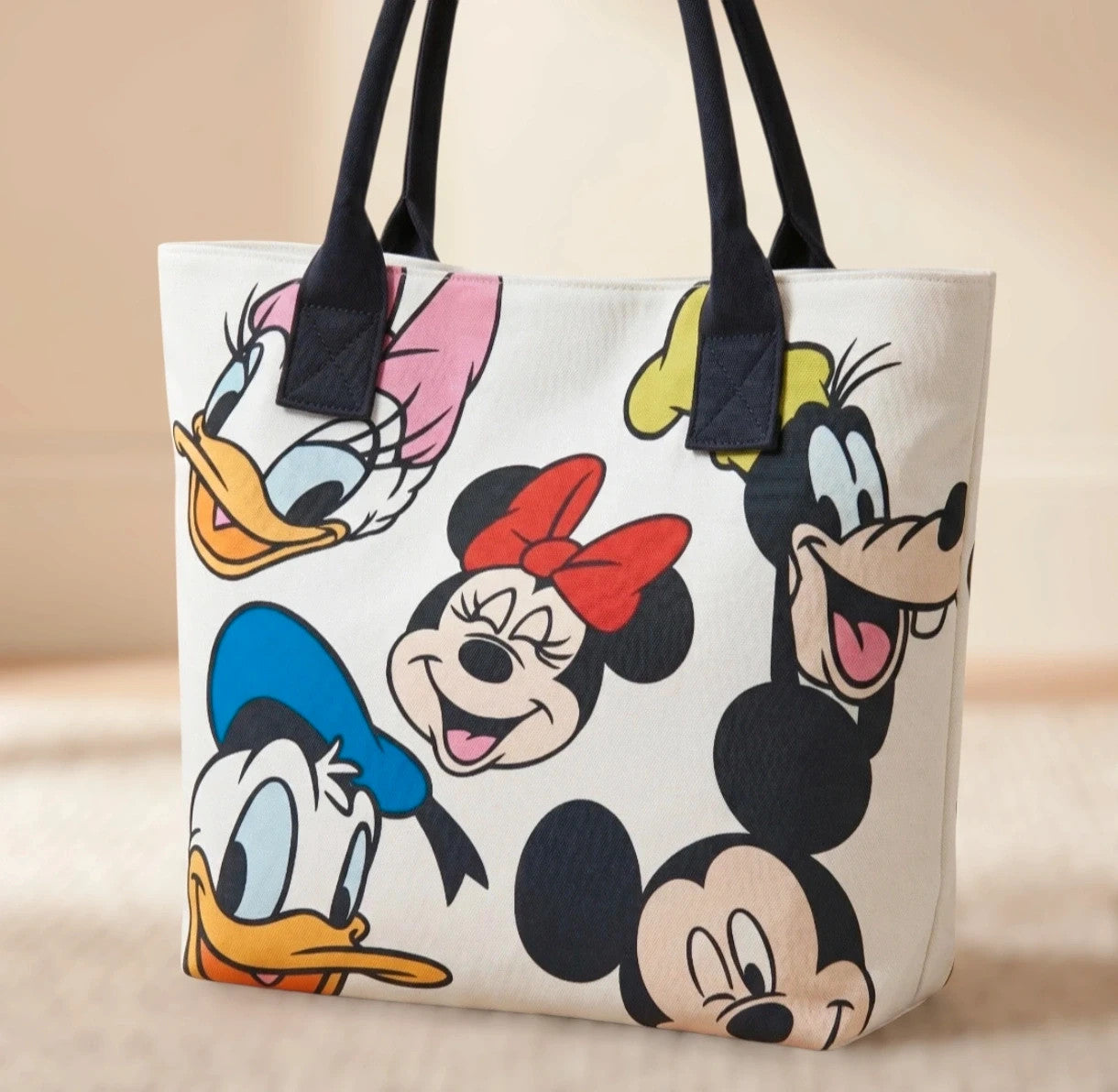 Cartoon cream shopping tote featuring Goofy design and synthetic material.