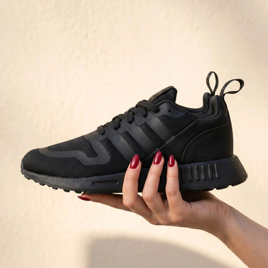Adidas black trainers with synthetic and textile material, classic design, original box included.