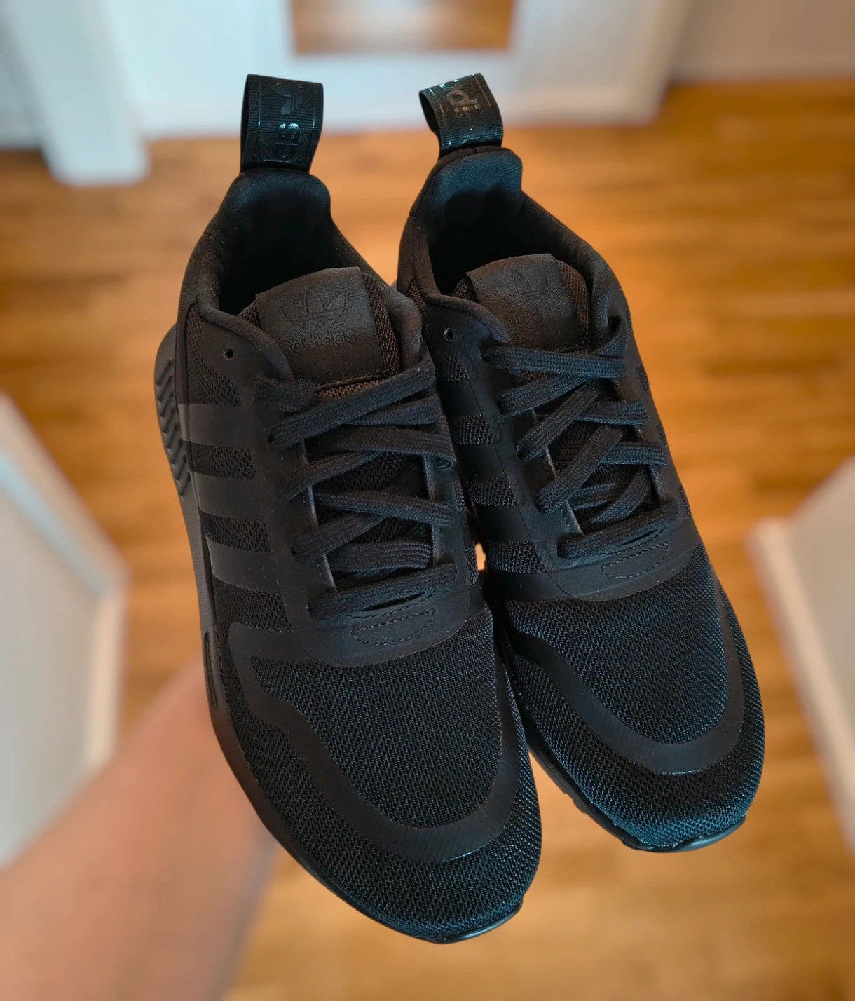 Adidas black trainers with synthetic and textile material, classic design, original box included.
