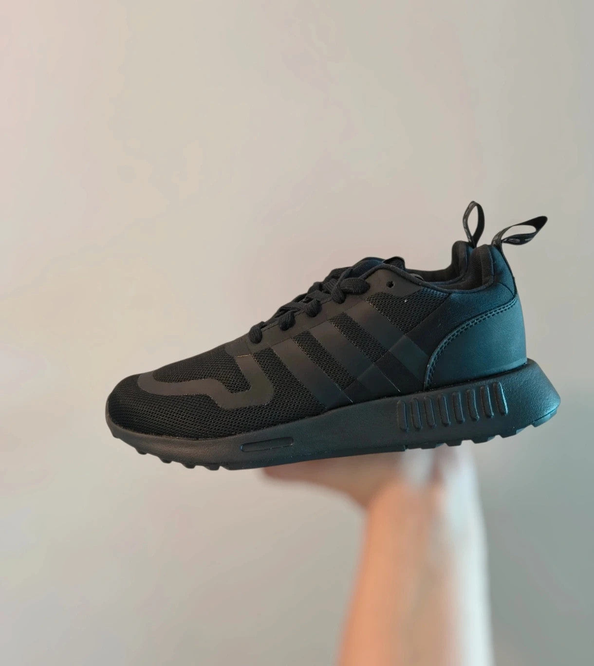 Adidas black trainers with synthetic and textile material, classic design, original box included.
