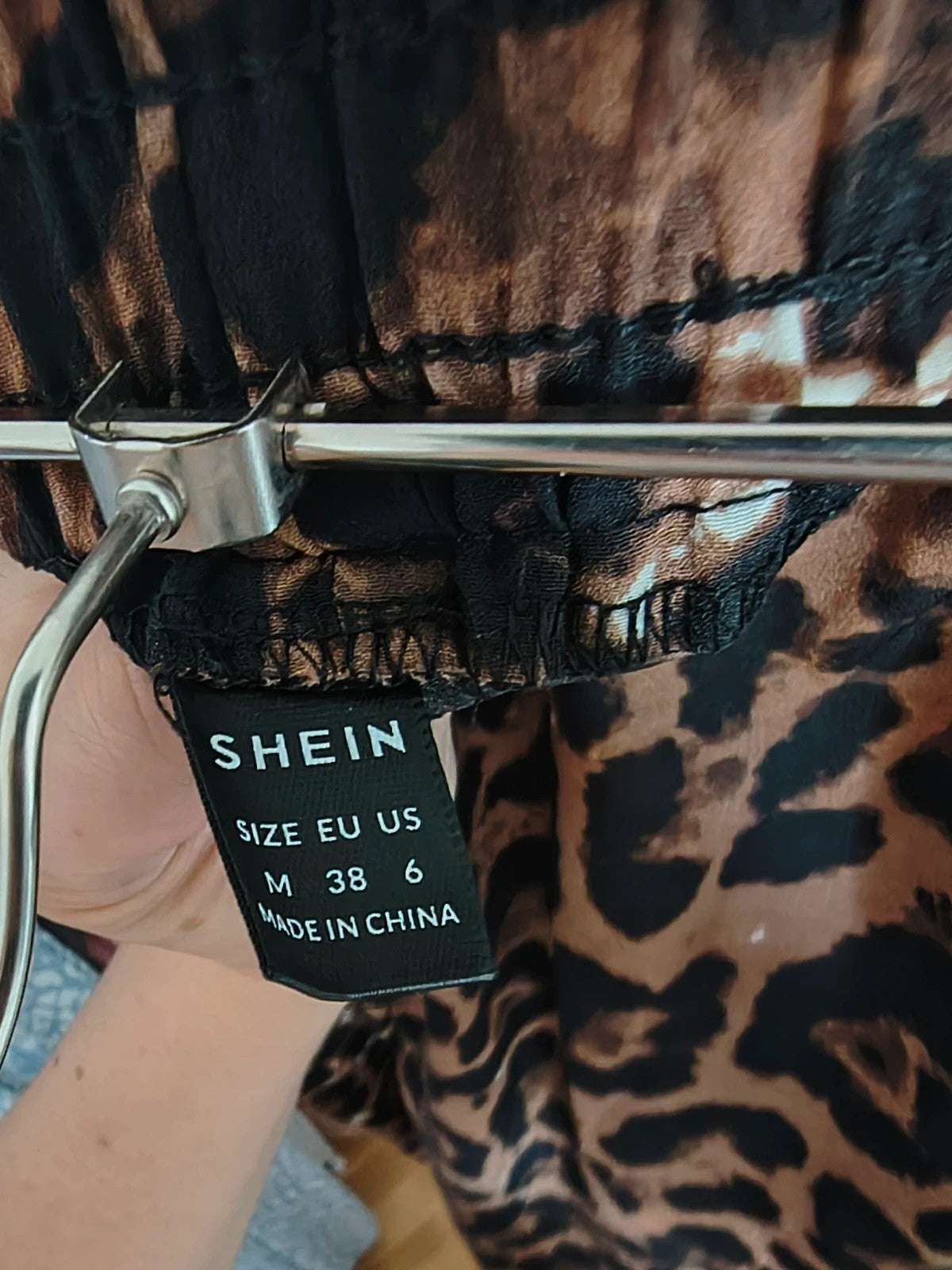SheIn brown animal print flared pants synthetic material with leopard pattern.