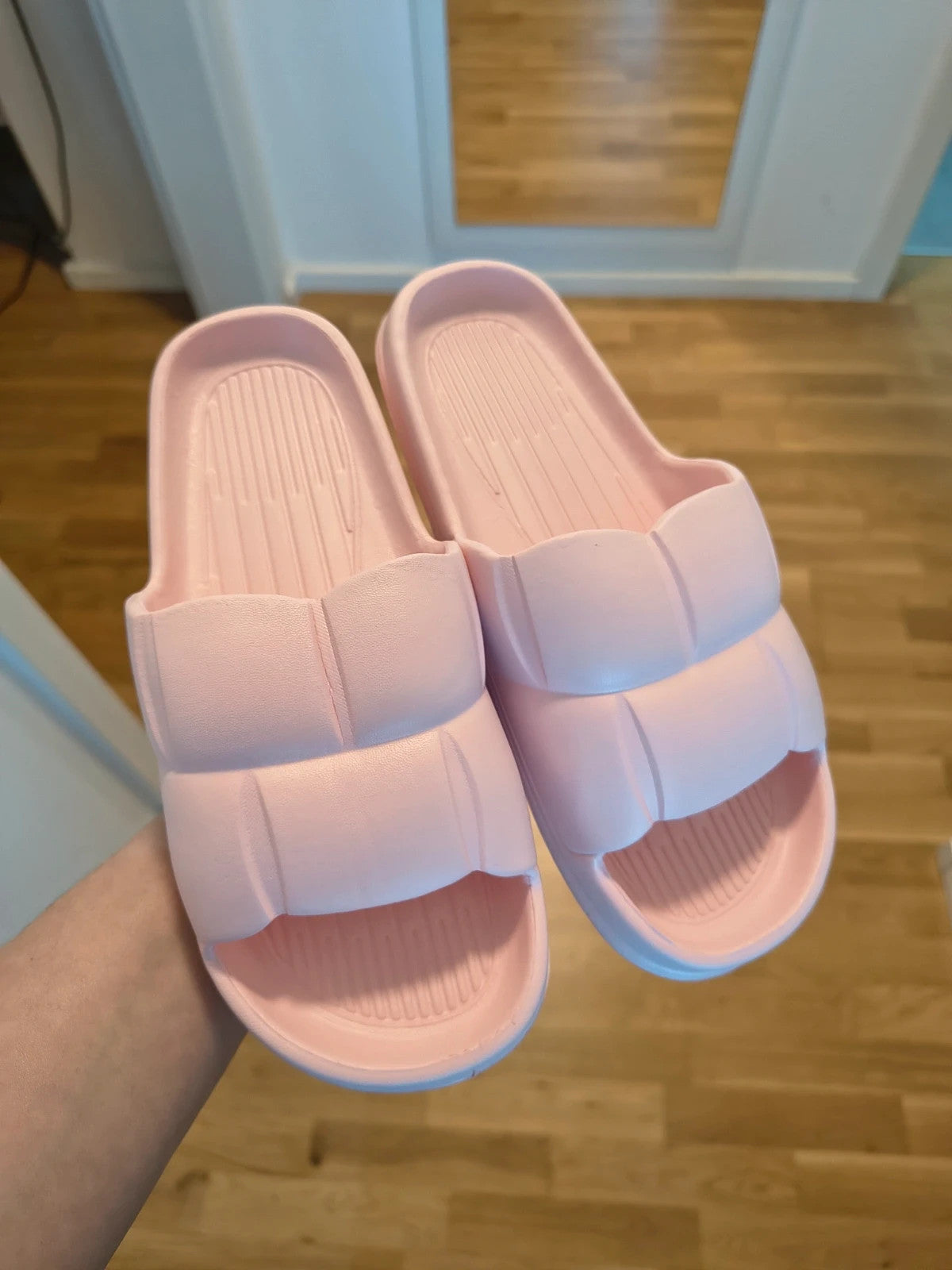 Slipper pink slides lightweight synthetic foam material with casual design.