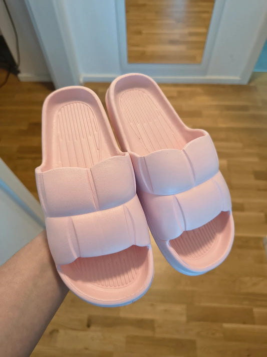 Slipper pink slides lightweight synthetic foam material with casual design.