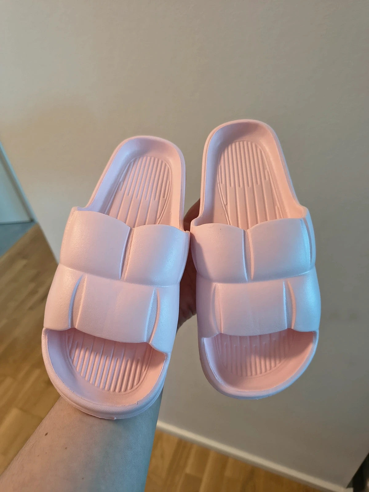 Slipper pink slides lightweight synthetic foam material with casual design.