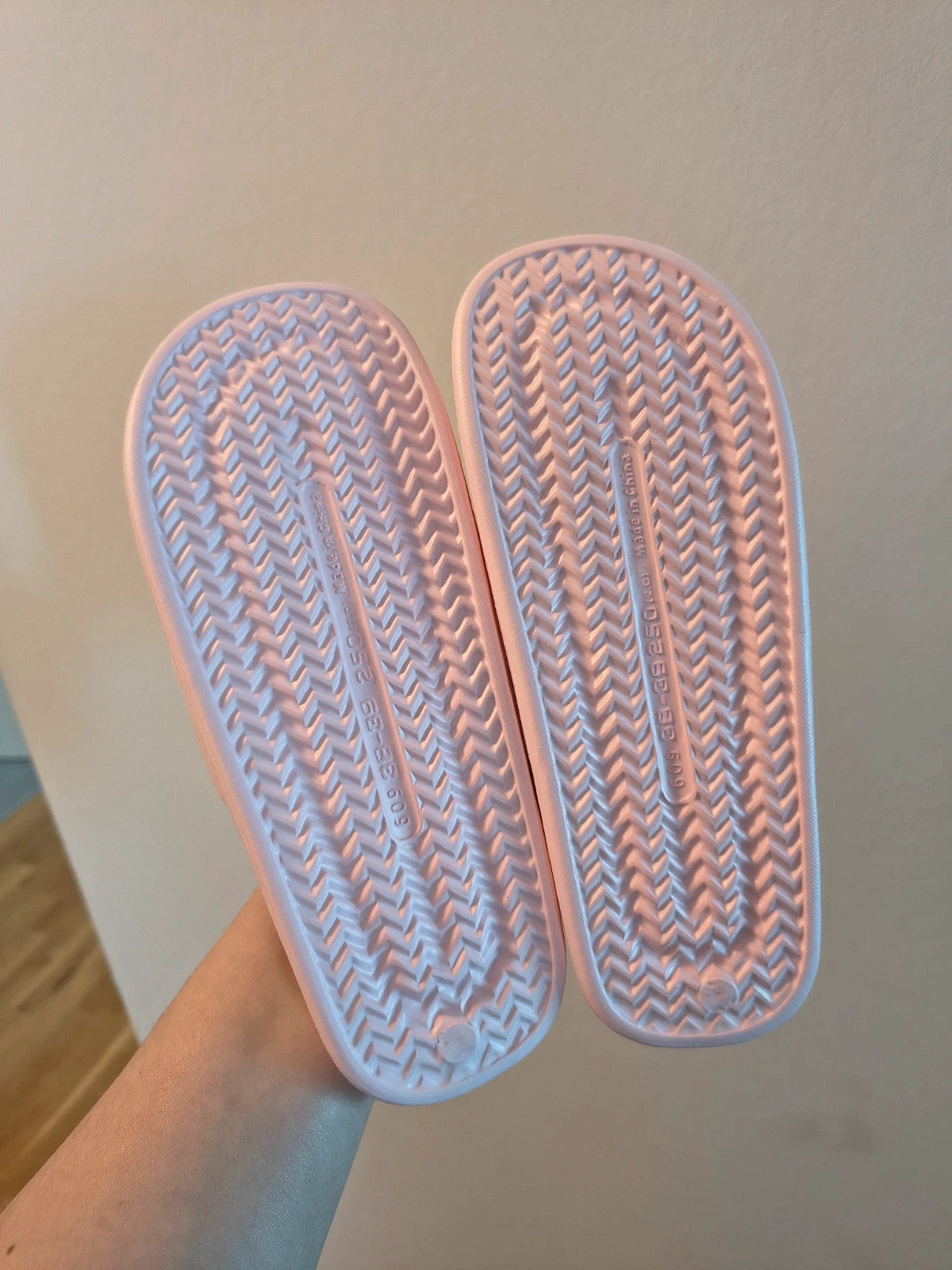 Slipper pink slides lightweight synthetic foam material with casual design.