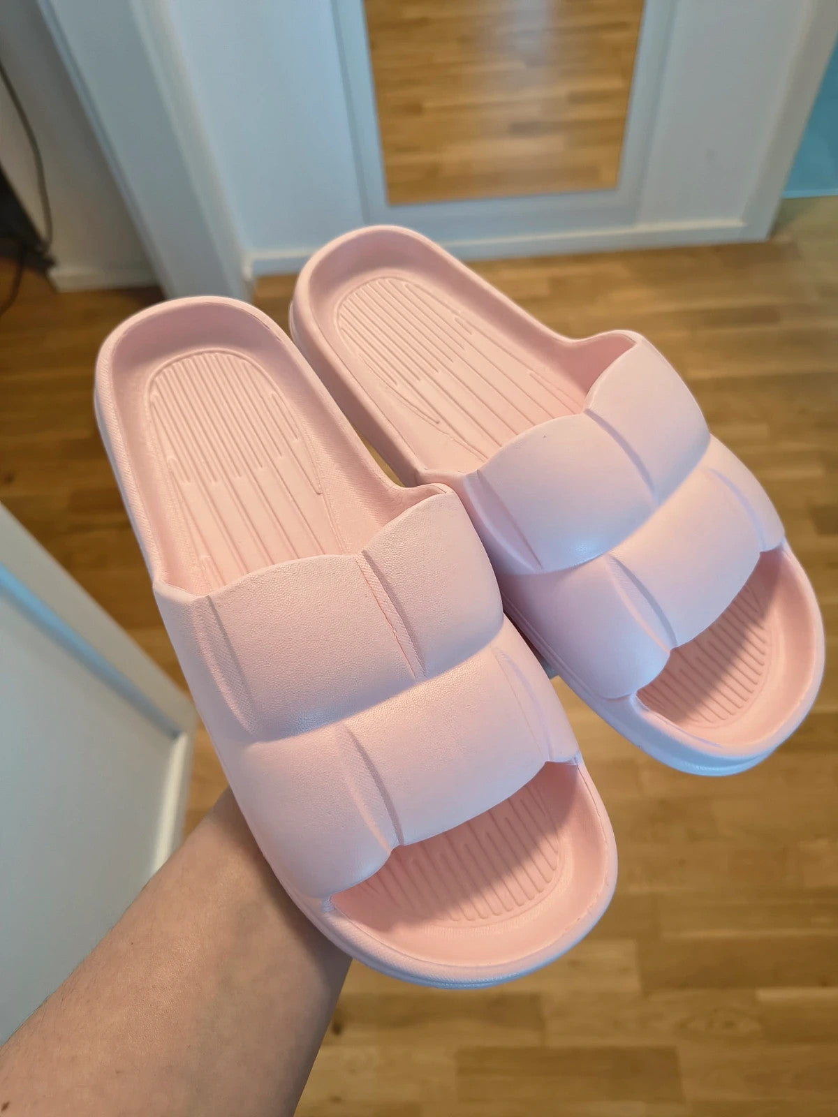 Slipper pink slides lightweight synthetic foam material with casual design.