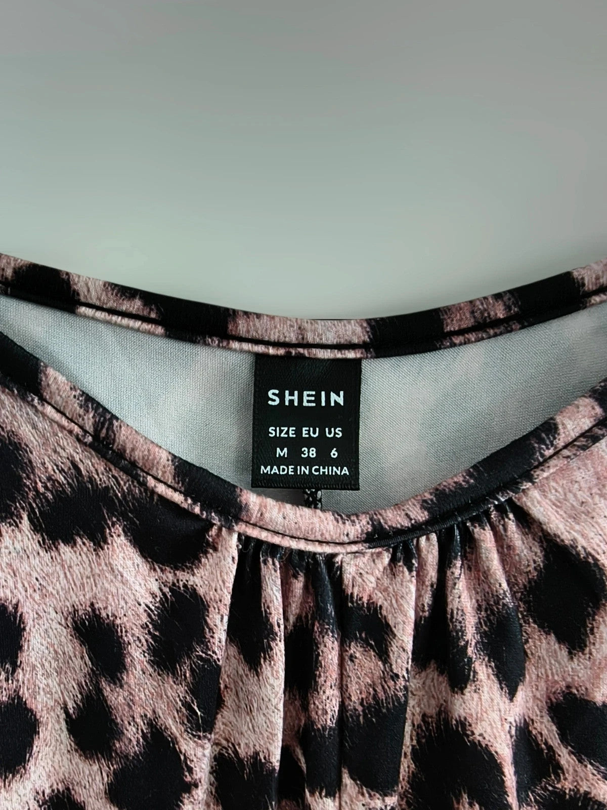 SheIn beige and brown jumpsuit with leopard print pattern and sleeveless design.