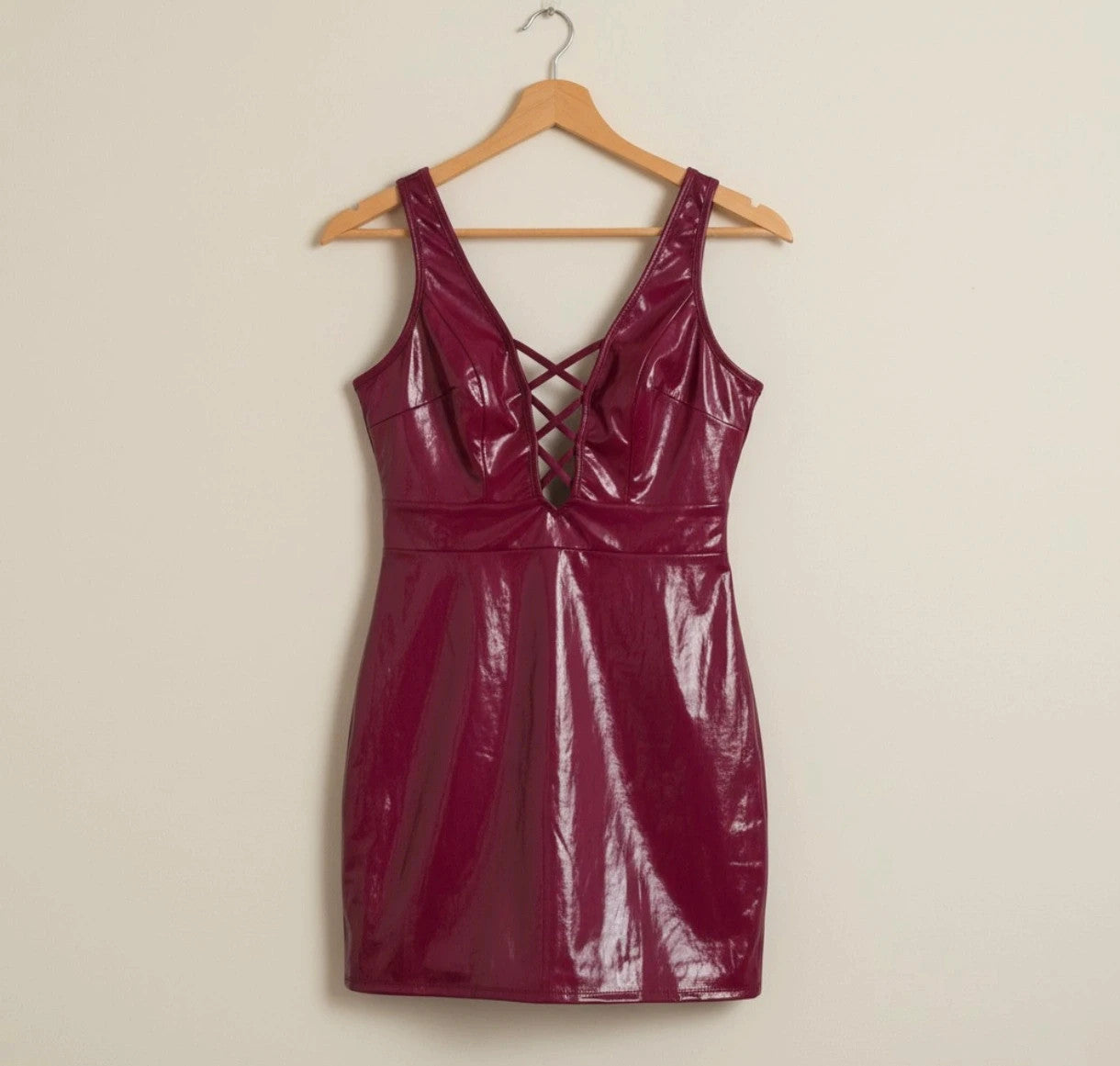 Bordeaux burgundy bandage dress with lace-up detail and glossy vinyl appearance.
