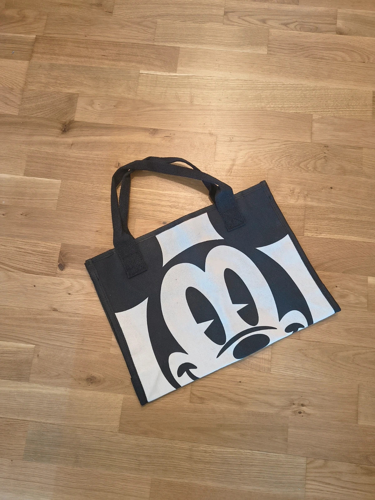 One Size black and cream shopping tote with zipper, synthetic and textile material.