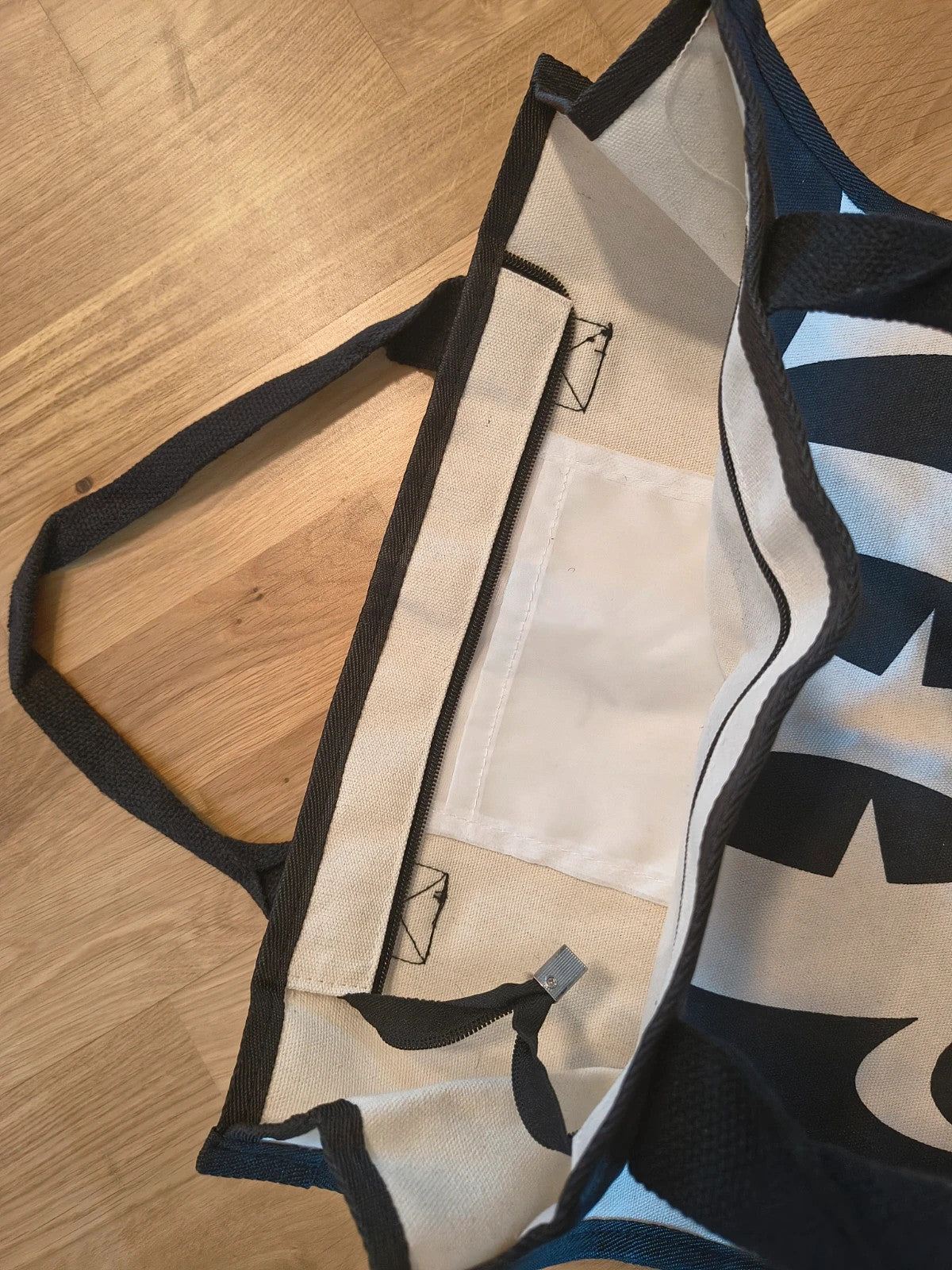 One Size black and cream shopping tote with zipper, synthetic and textile material.