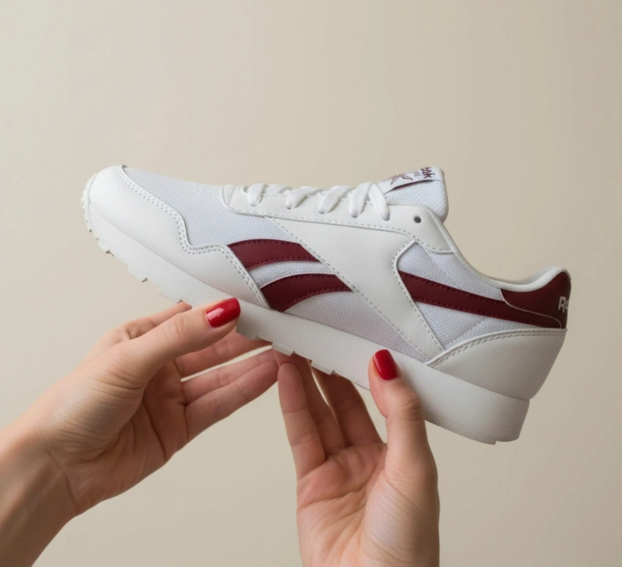 Reebok white trainers with synthetic and textile materials, featuring classic design elements.