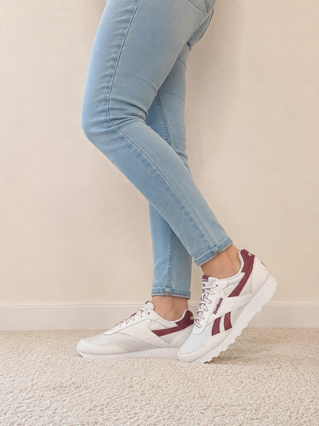 Reebok white trainers with synthetic and textile materials, featuring classic design elements.