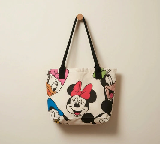 Kleine Tasche cream shopping tote with colorful cartoon comic print and sturdy handles.