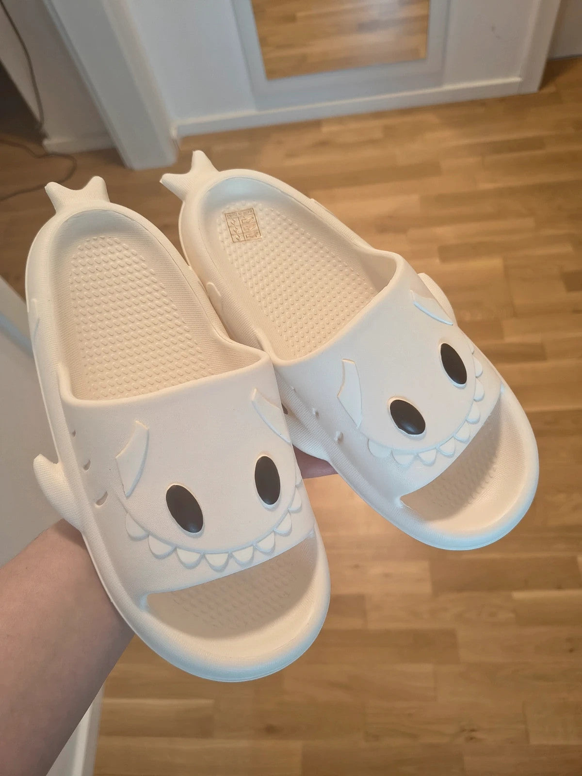 Perfekt cream slippers with monster design, featuring playful face and lightweight material.