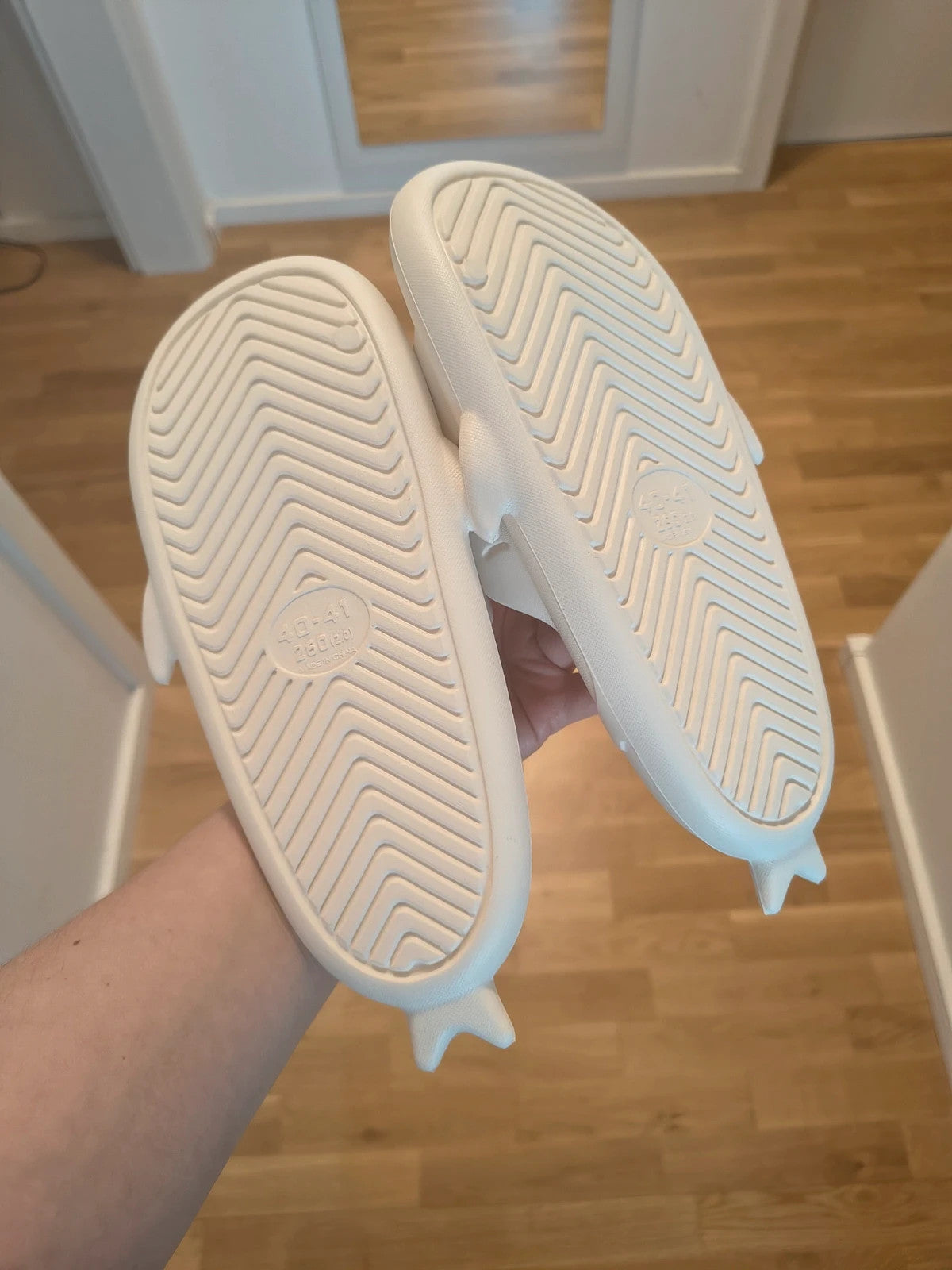Perfekt cream slippers with monster design, featuring playful face and lightweight material.