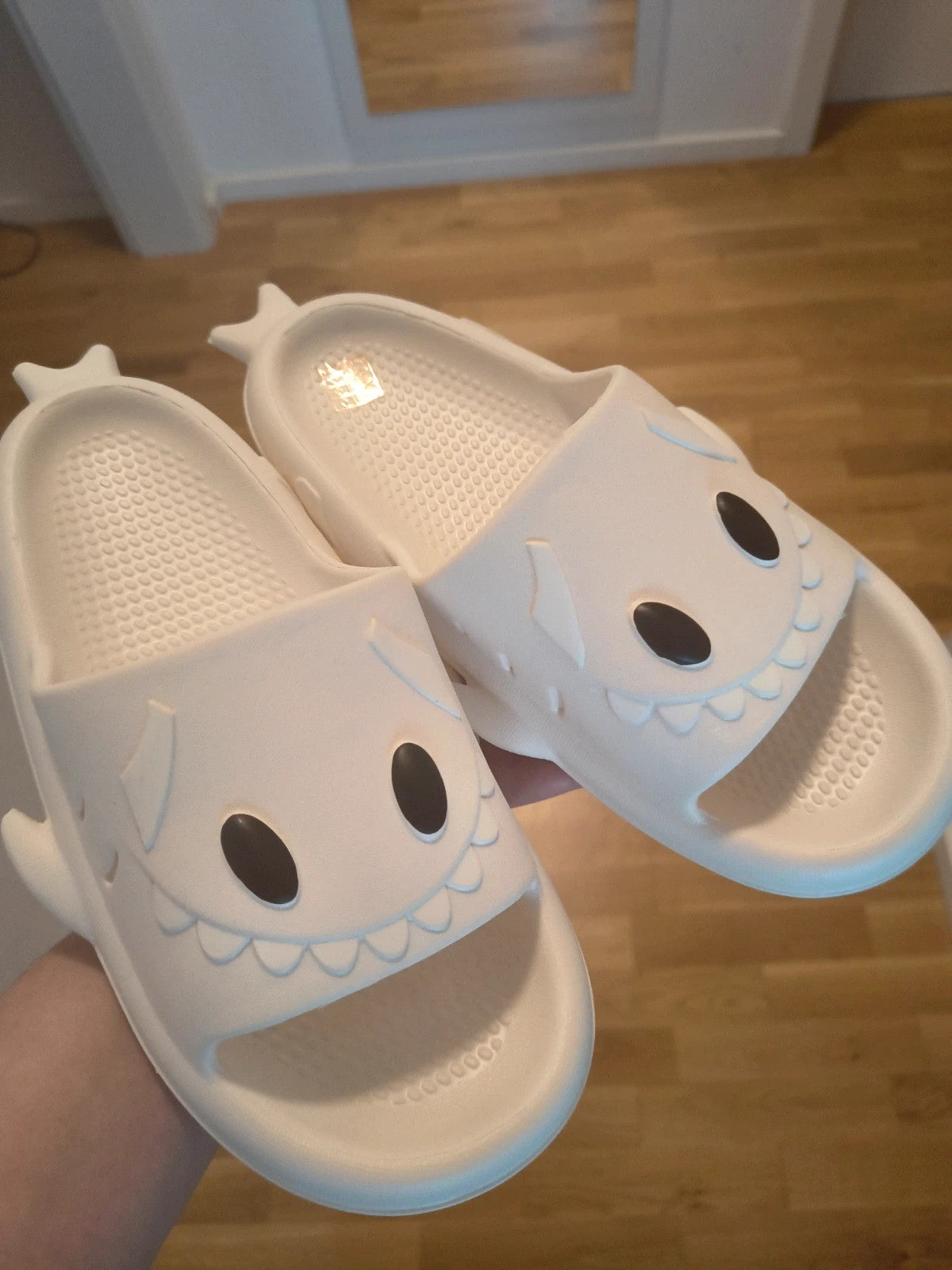 Perfekt cream slippers with monster design, featuring playful face and lightweight material.