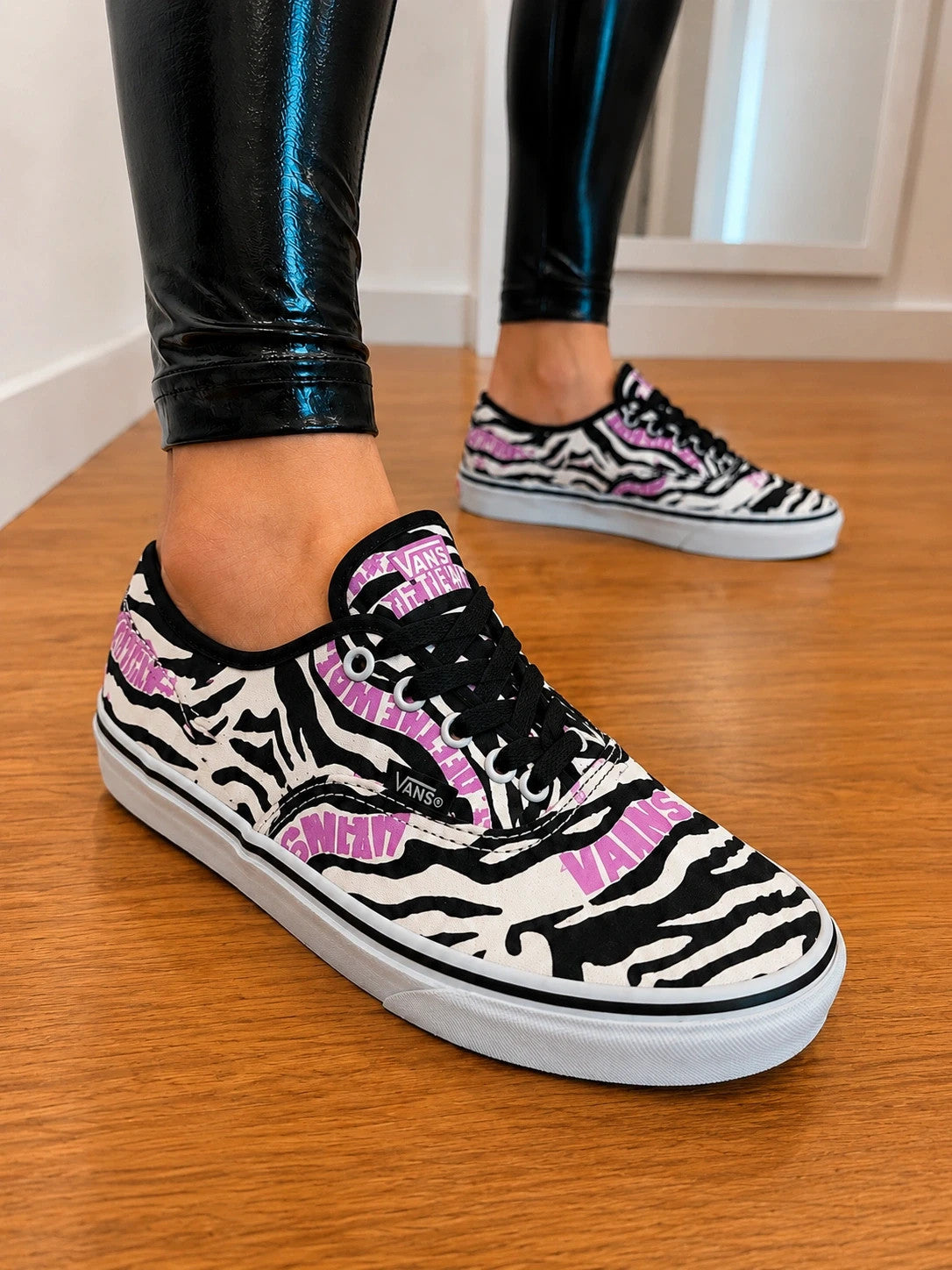 VANS trainers black white zebra print with pink logo and black laces.