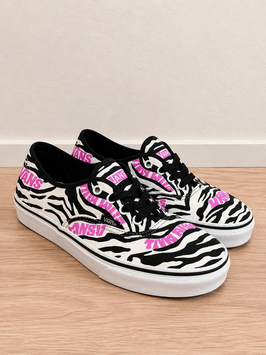 VANS trainers black white zebra print with pink logo and black laces.