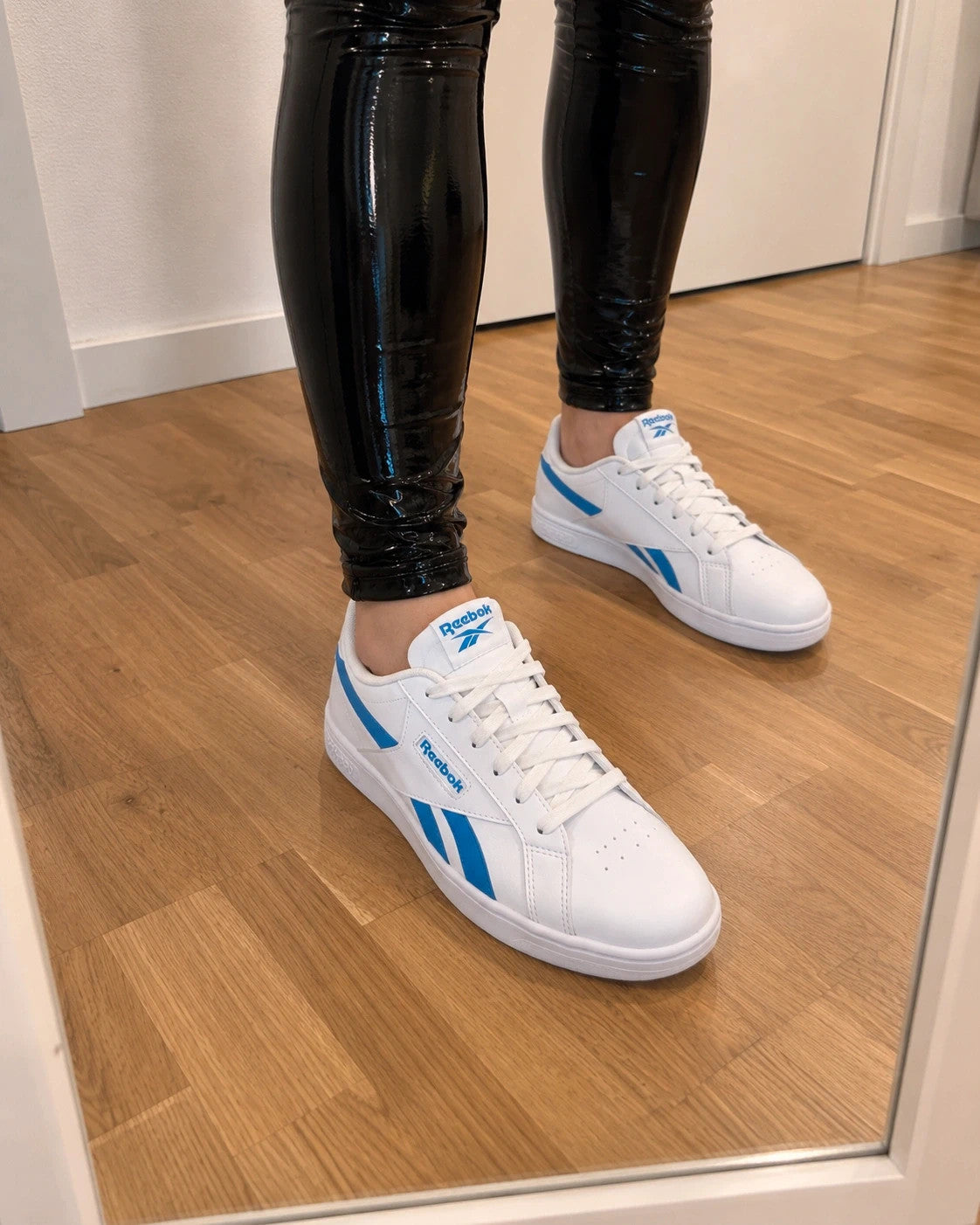 Reebok kids trainers white with blue details, classic lace-up design, synthetic material.
