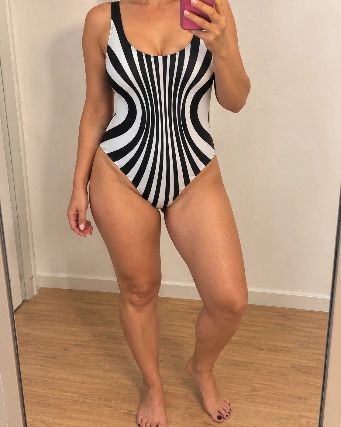 XXL one-piece swimsuit black and white striped optical print with deep neckline.