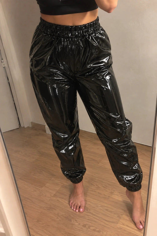 Stark black joggers in shiny wetlook finish with elastic waistband and cuffs.