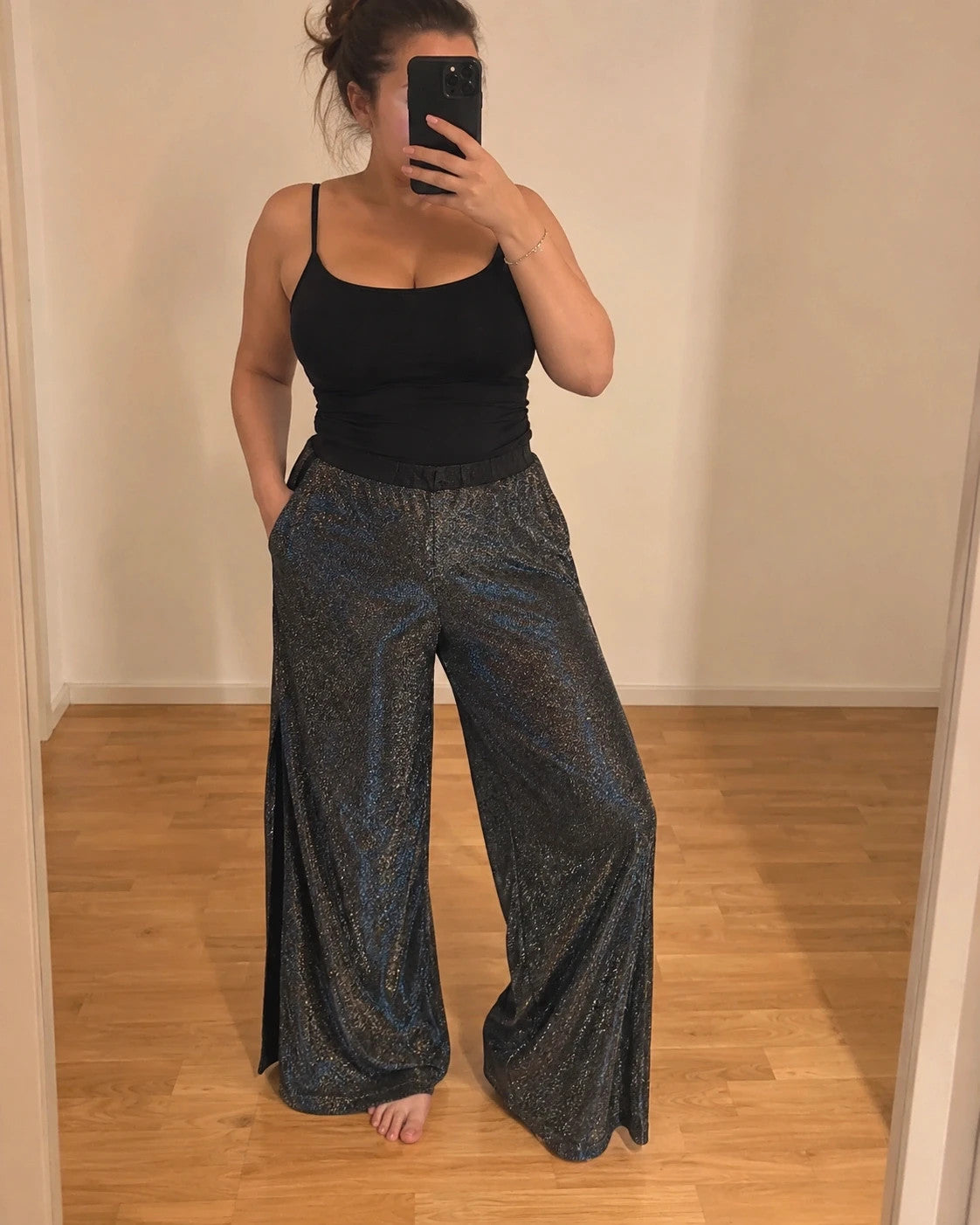 SheIn black and silver glitter flared pants with side slits and shimmering fabric.