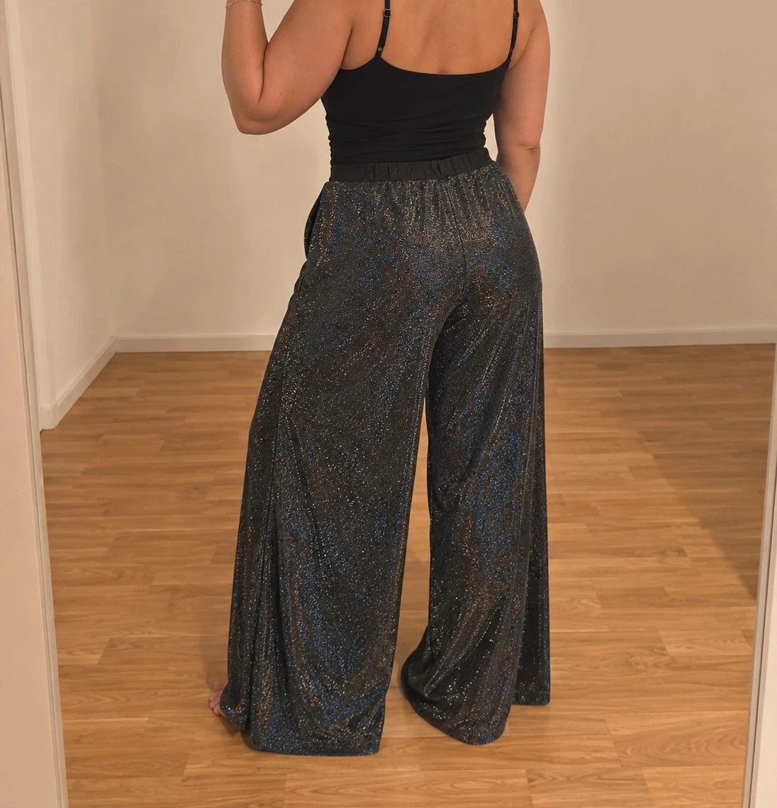SheIn black and silver glitter flared pants with side slits and shimmering fabric.