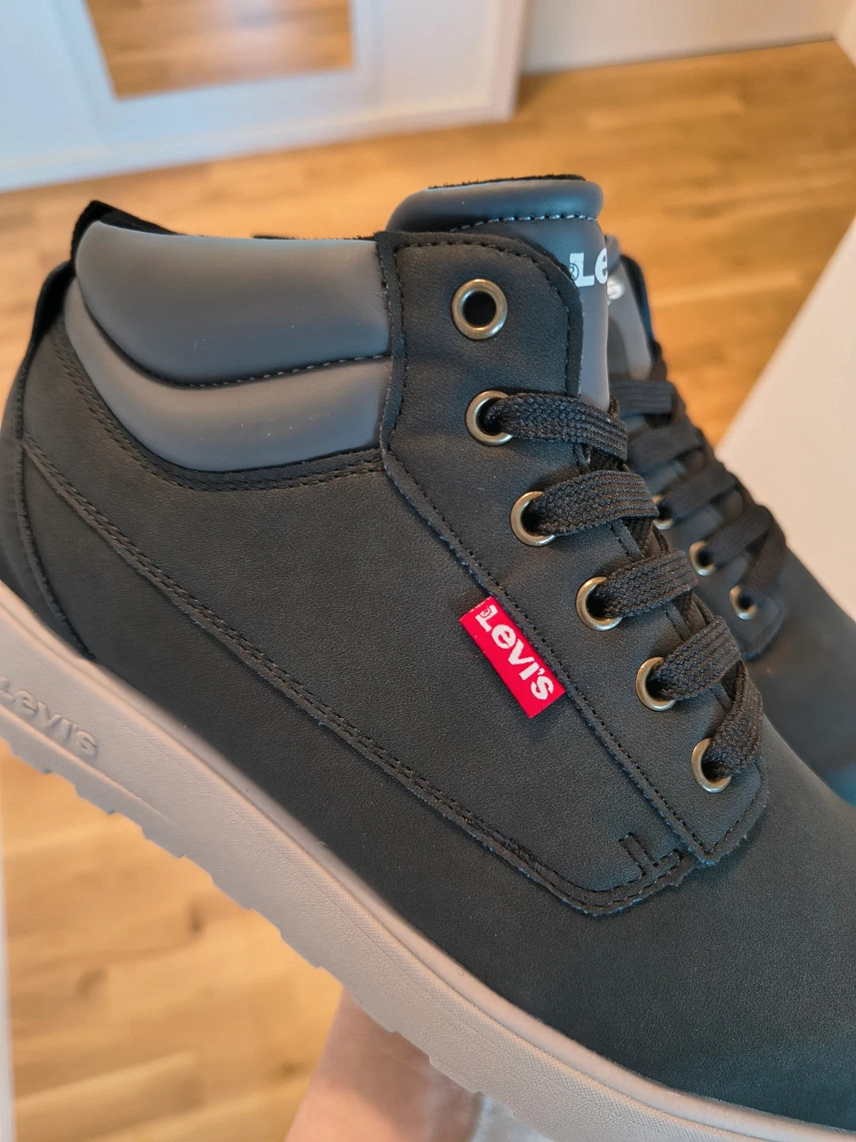 Levi's black and grey sneaker boots with logo details and padded high shaft.