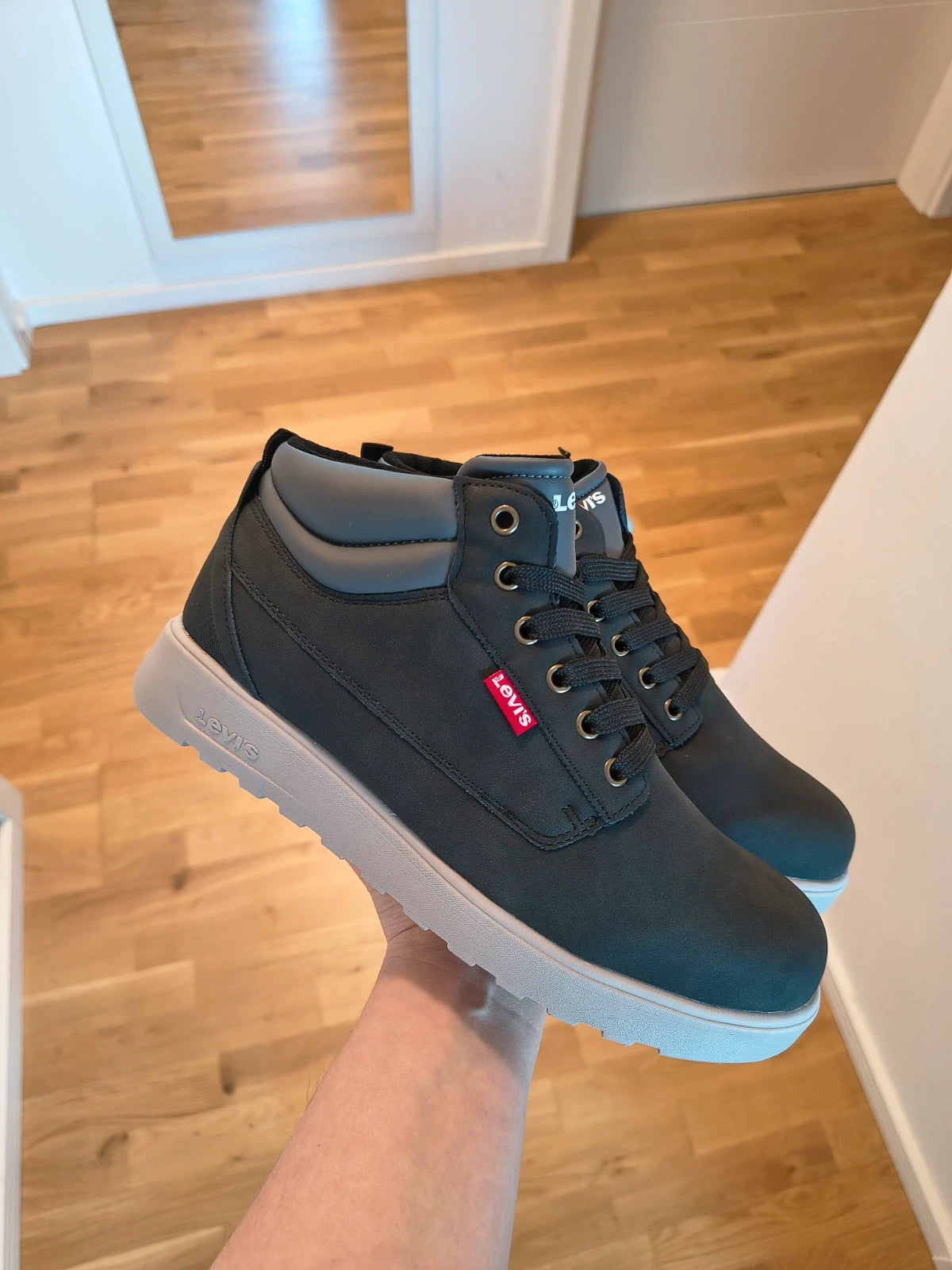 Levi's black and grey sneaker boots with logo details and padded high shaft.