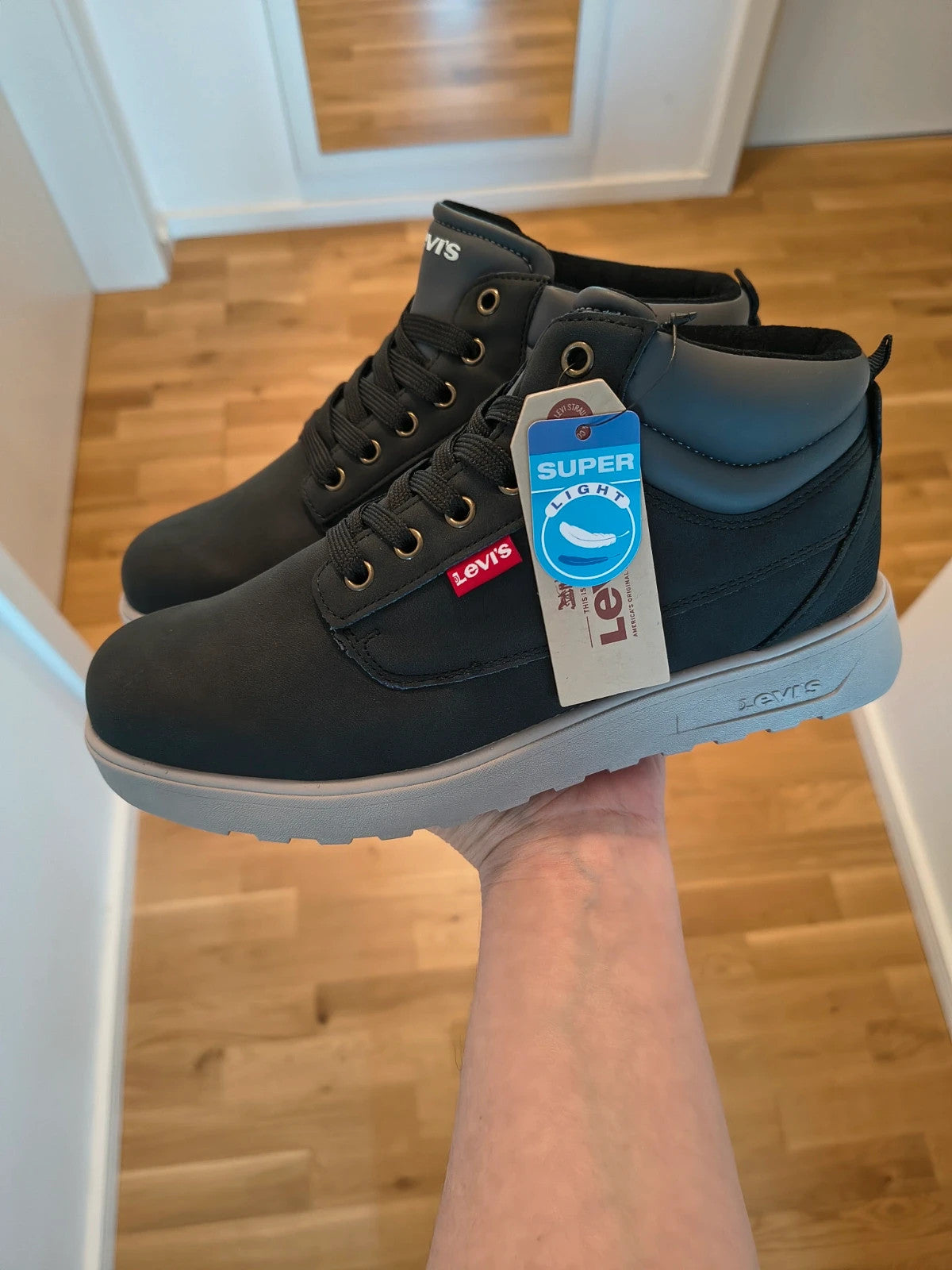 Levi's black and grey sneaker boots with logo details and padded high shaft.