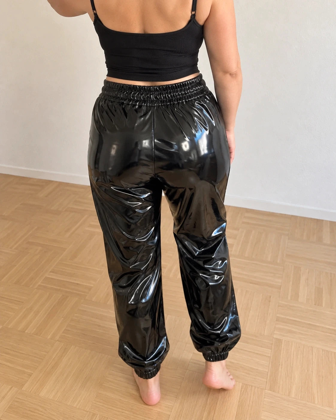 Che black joggers shiny wetlook finish with elastic waistband and cuffs.
