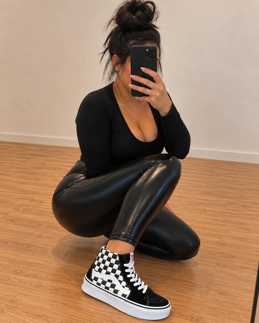VANS black and white checkerboard high-top trainers with distinctive platform sole and logo.