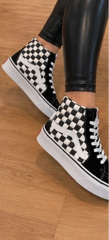 VANS black and white checkerboard high-top trainers with distinctive platform sole and logo.