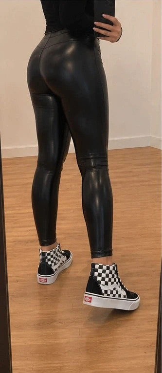 VANS black and white checkerboard high-top trainers with distinctive platform sole and logo.