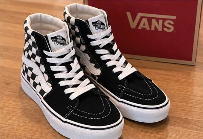 VANS black and white checkerboard high-top trainers with distinctive platform sole and logo.