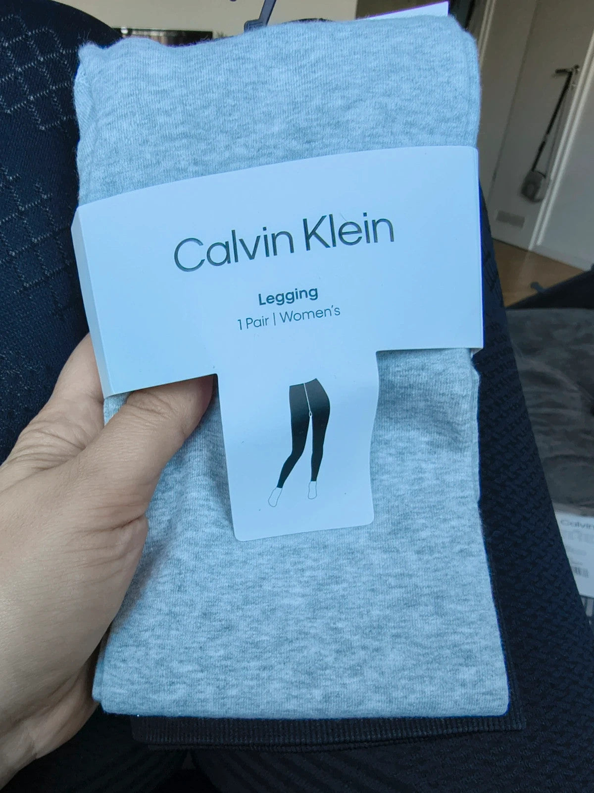 Calvin Klein grey bicycle tights with wide black logo waistband, fitted design.
