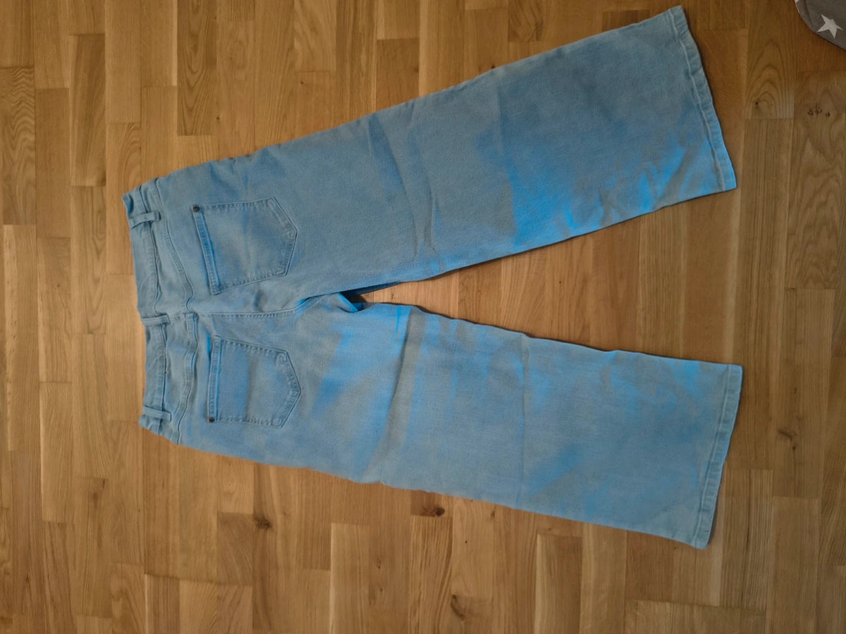 Rainbow blue straight jeans with unique overlapping waistband and two-button closure.